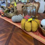 A table with pumpkins and baskets on it