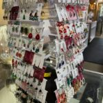 A display of earrings on top of a glass table.