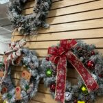 A wall with several wreaths hanging on it.