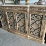 A large wooden buffet with metal accents on the front.