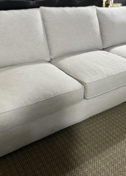 Light beige upholstered sofa on patterned carpet