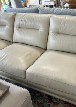 Beige leather three-seater sofa with ottoman