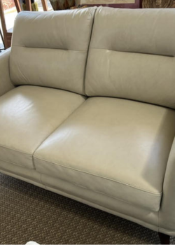 Light beige leather loveseat with stitched back