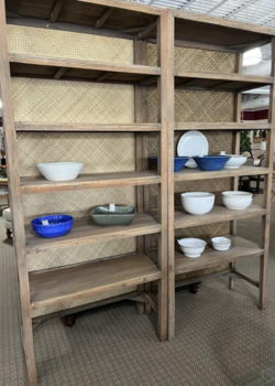 Woven back wooden shelves displaying ceramic bowls