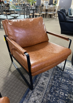 Tan leather lounge chair with black metal frame