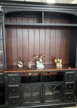 Dark wood entertainment center with porcelain figurines