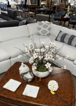 White sectional sofa with floral centerpiece