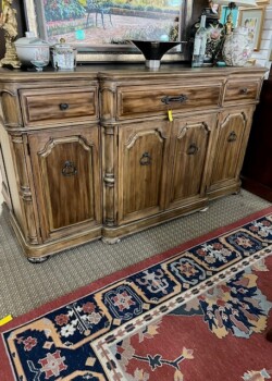 Wooden sideboard with decorative elements.