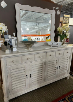 White wooden sideboard with large mirror.