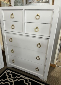 White dresser with gold handles.