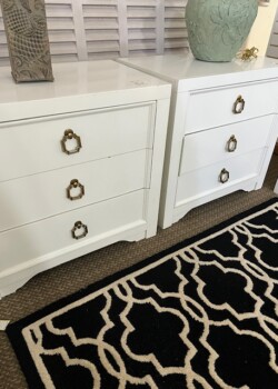 White nightstands with decorative knobs.